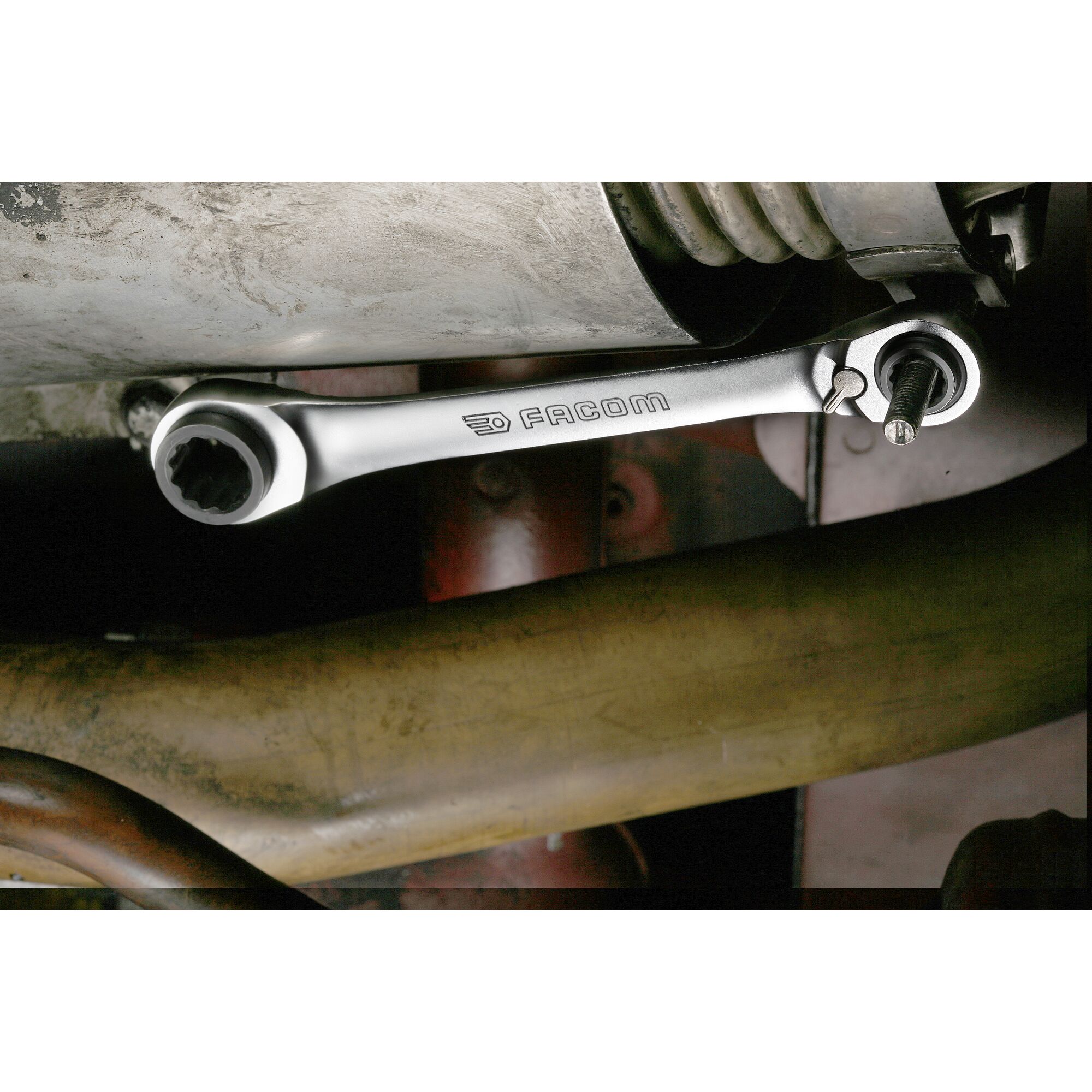 Photo of Facom 64C_J2PB ratcheting wrench in use on a bolt within a car engine bay.
